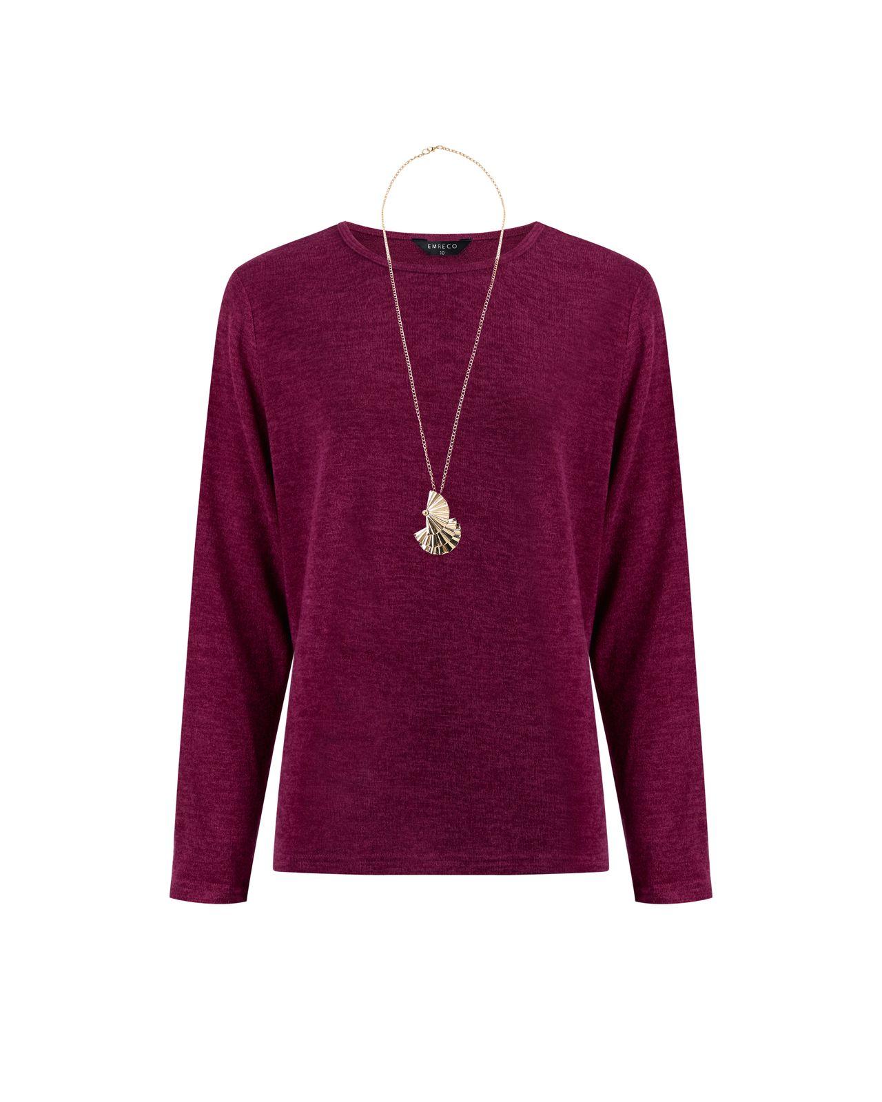 a woman wearing a purple sweater and a necklace