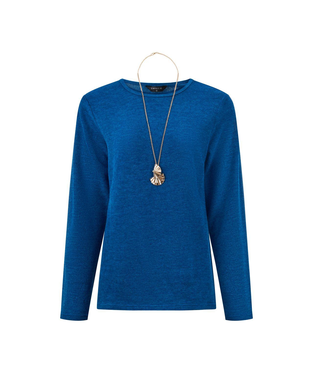 a woman wearing a blue sweater and a necklace