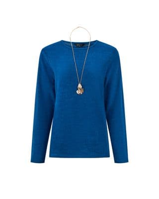 a woman wearing a blue sweater and a necklace