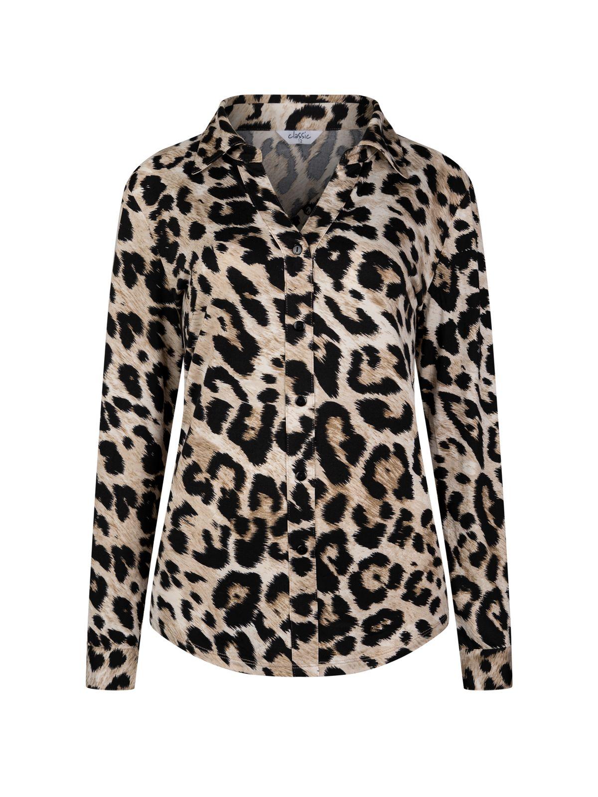 a woman wearing a leopard print shirt
