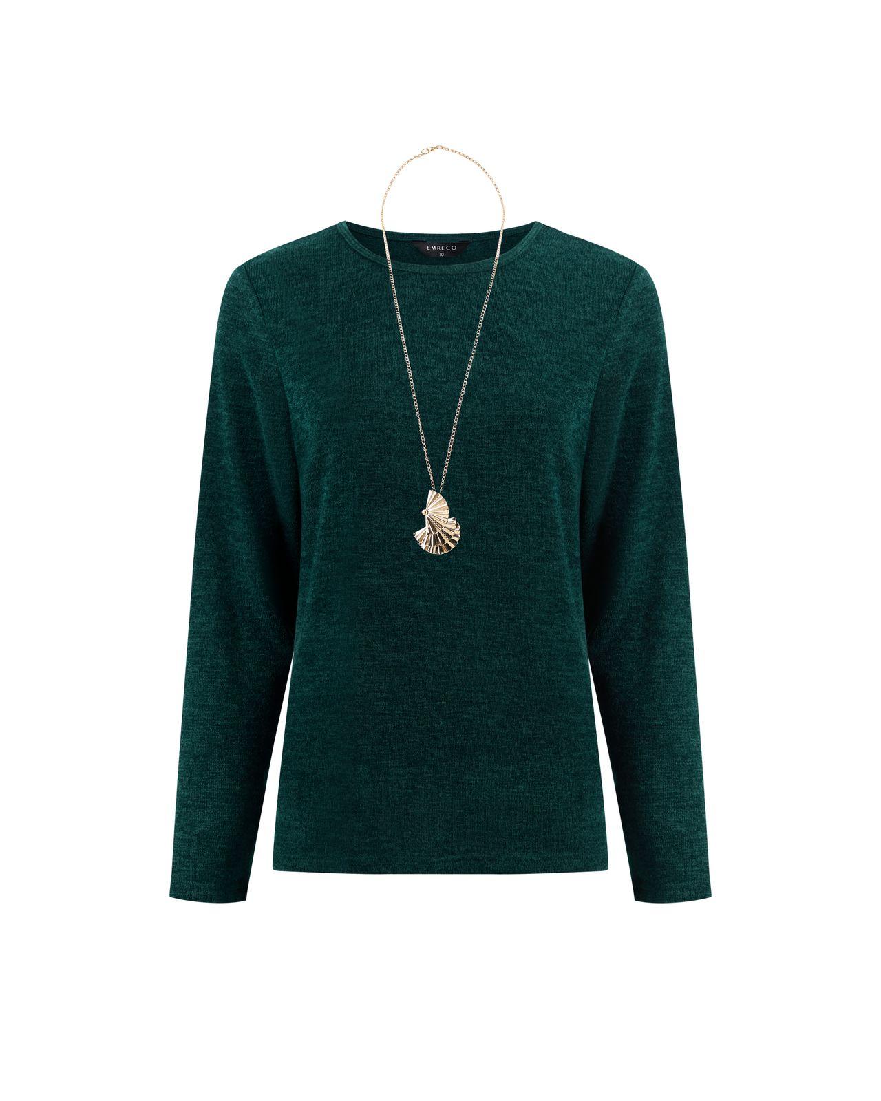 a woman wearing a green sweater and a necklace