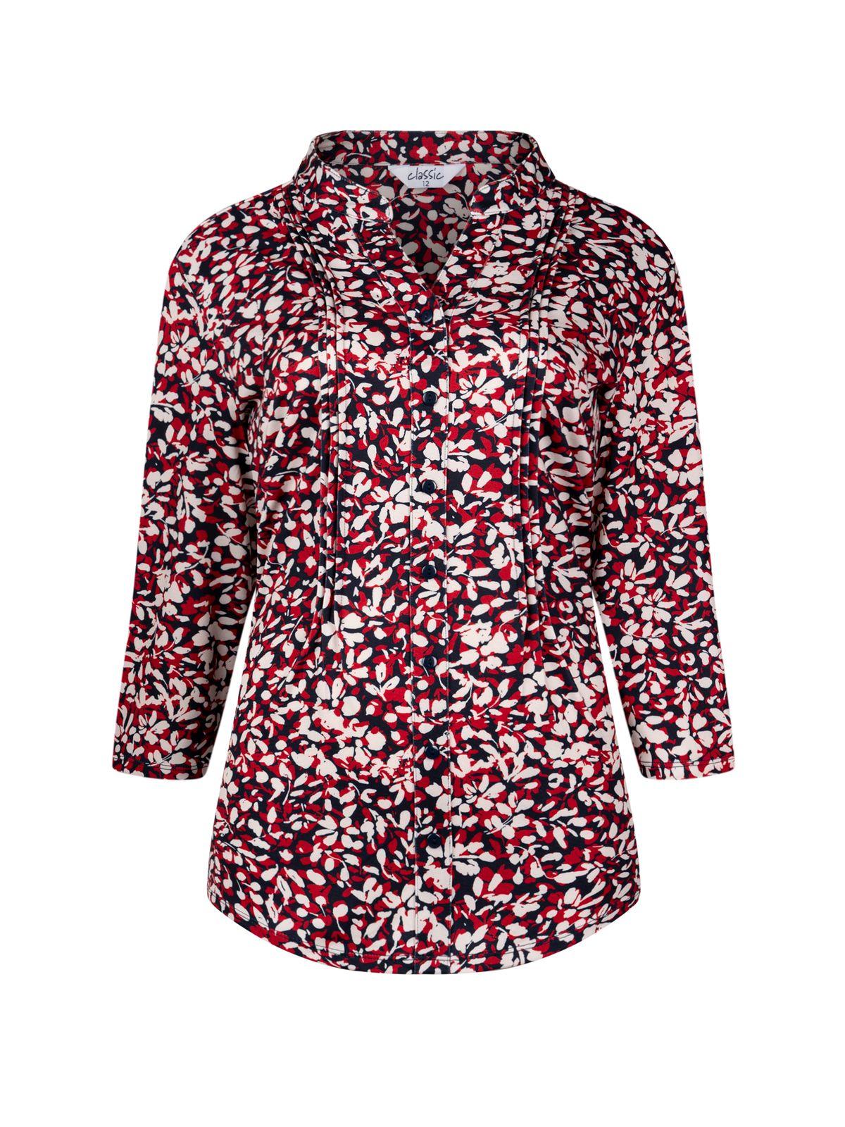 a woman wearing a red and white shirt