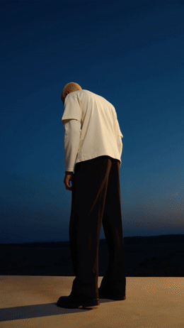 a man in a white shirt and black pants