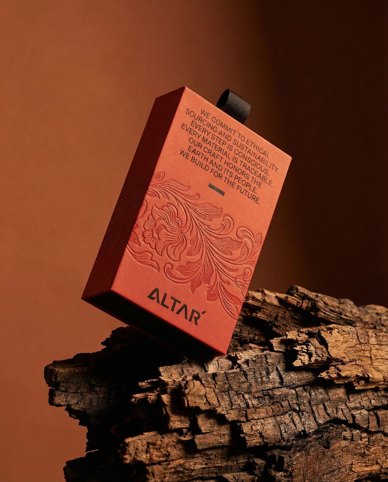 a red box sitting on top of a piece of wood