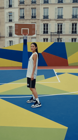 a person standing on a court with a basketball hoop