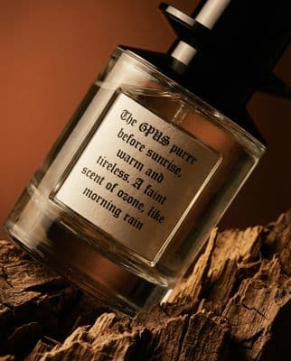 a bottle of perfume sitting on top of a wooden table