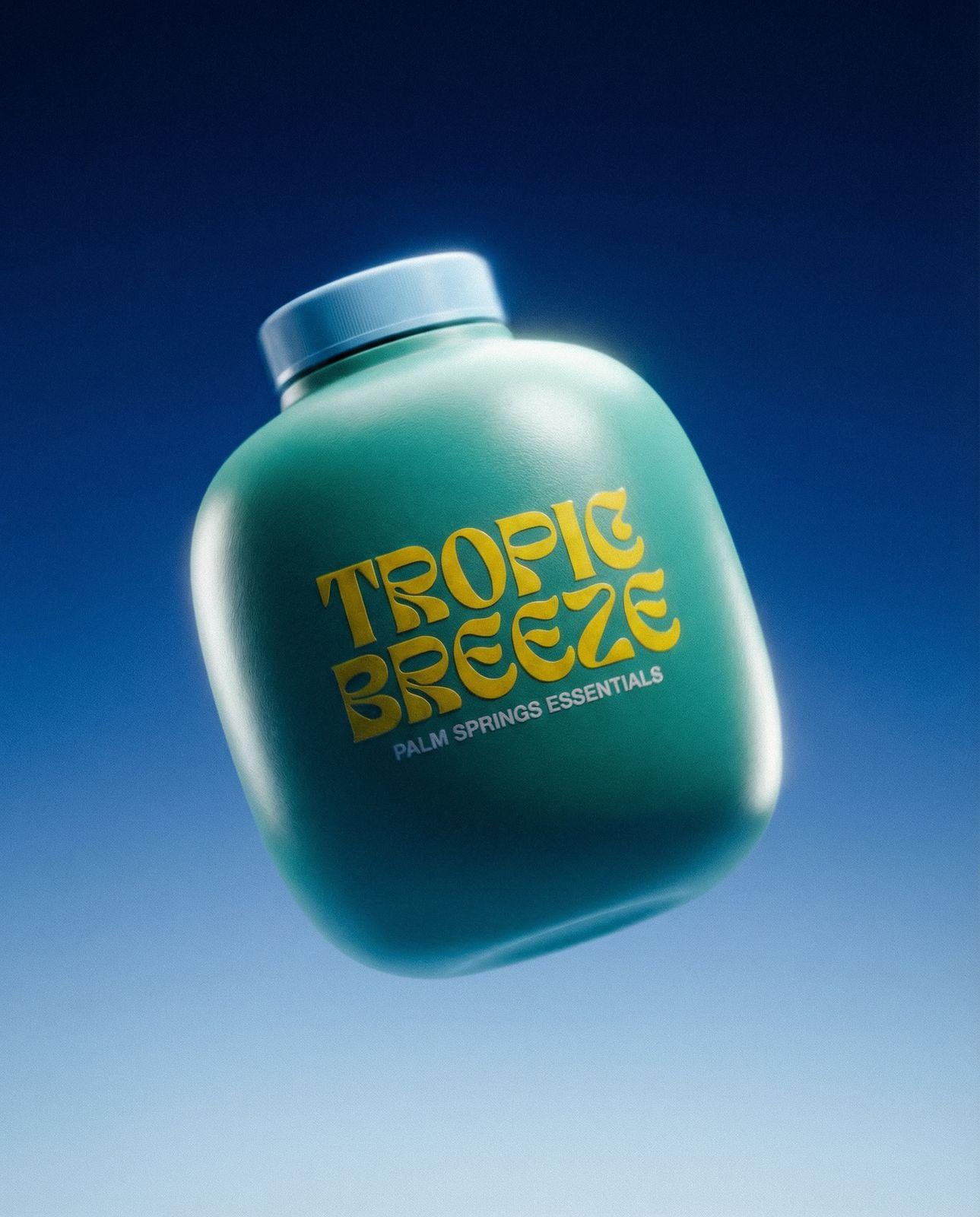 a bottle of tropic breeze is flying through the air