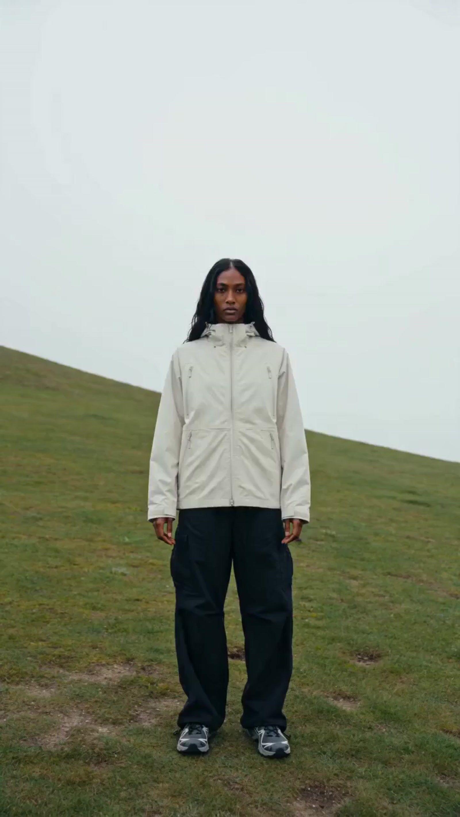 a person standing on a grass covered hill