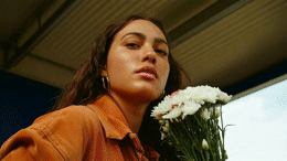 a woman holding a bouquet of white flowers