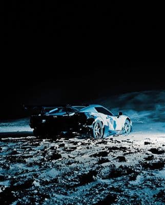 a car is parked in the middle of the desert