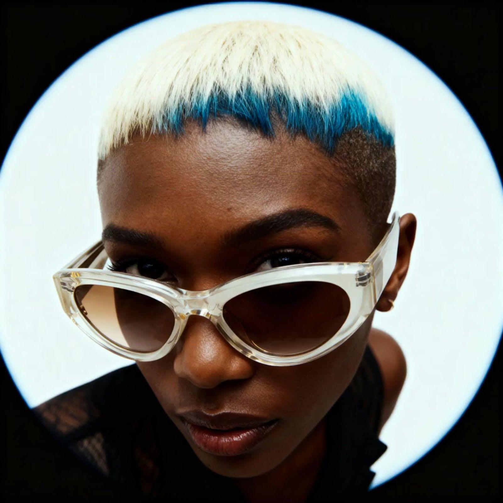 a close up of a person wearing a pair of sunglasses