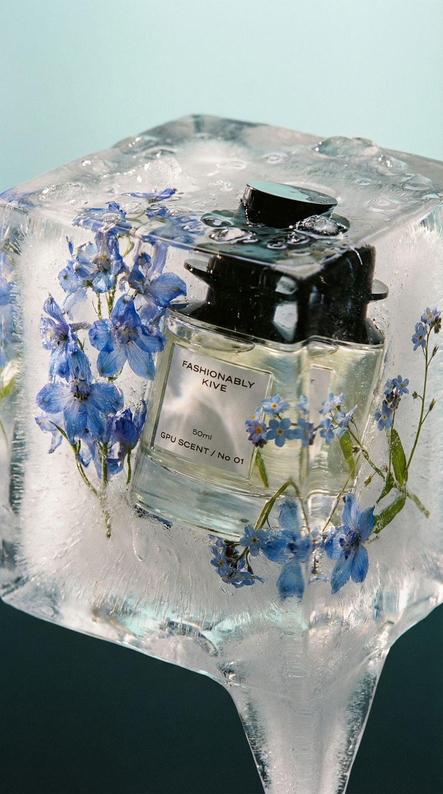 a bottle of perfume sitting on top of an ice block