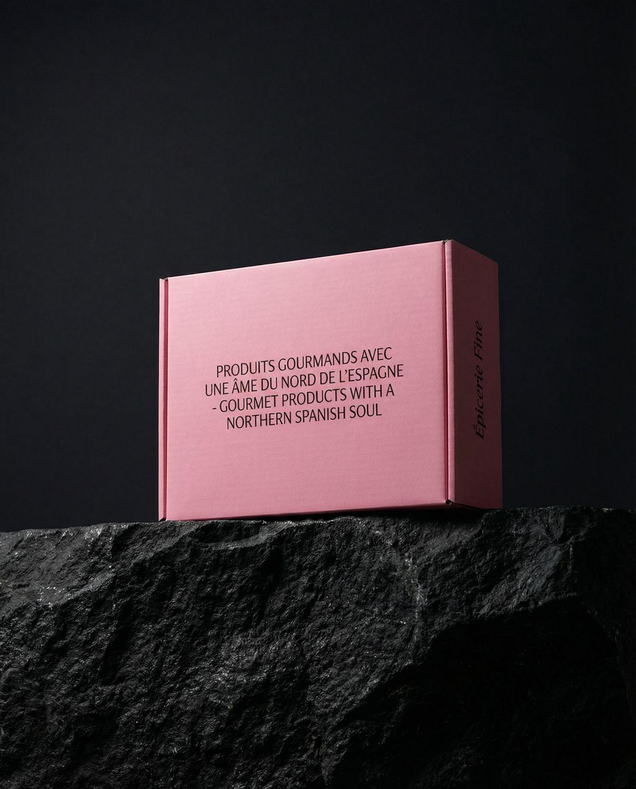 a pink box sitting on top of a rock