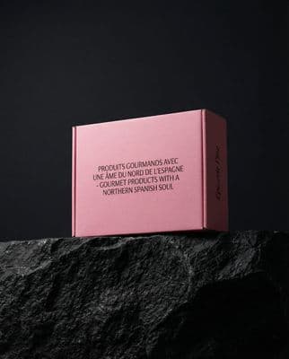 a pink box sitting on top of a rock