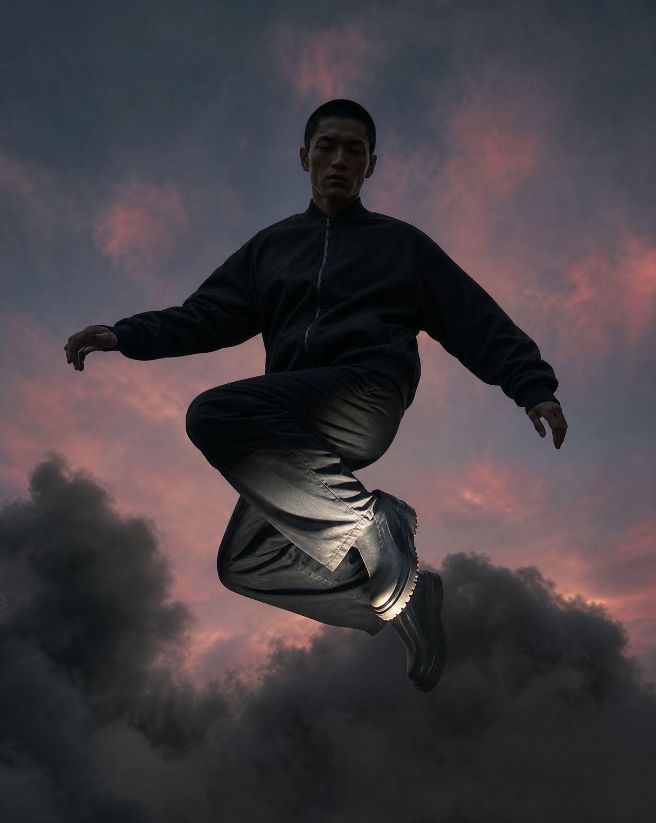 a man jumping in the air on a cloudy day