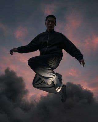 a man jumping in the air on a cloudy day