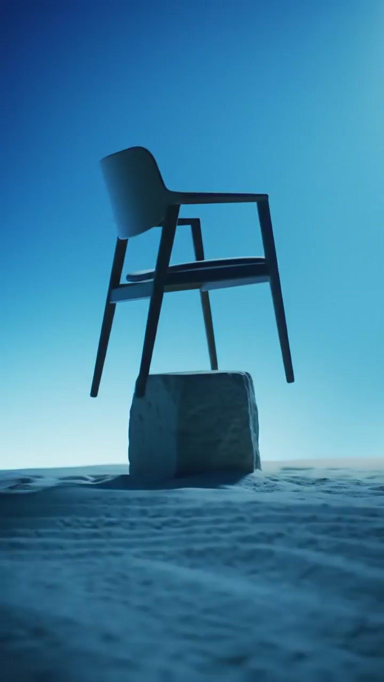 a chair sitting on top of a rock in the ocean
