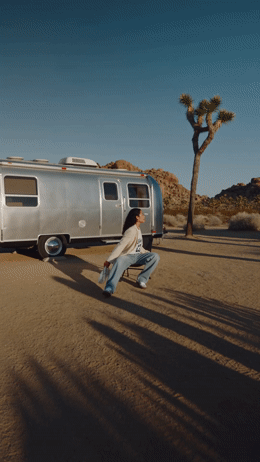 a man walking in front of a silver trailer
