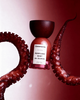 an octopus with a bottle of perfume in it's mouth