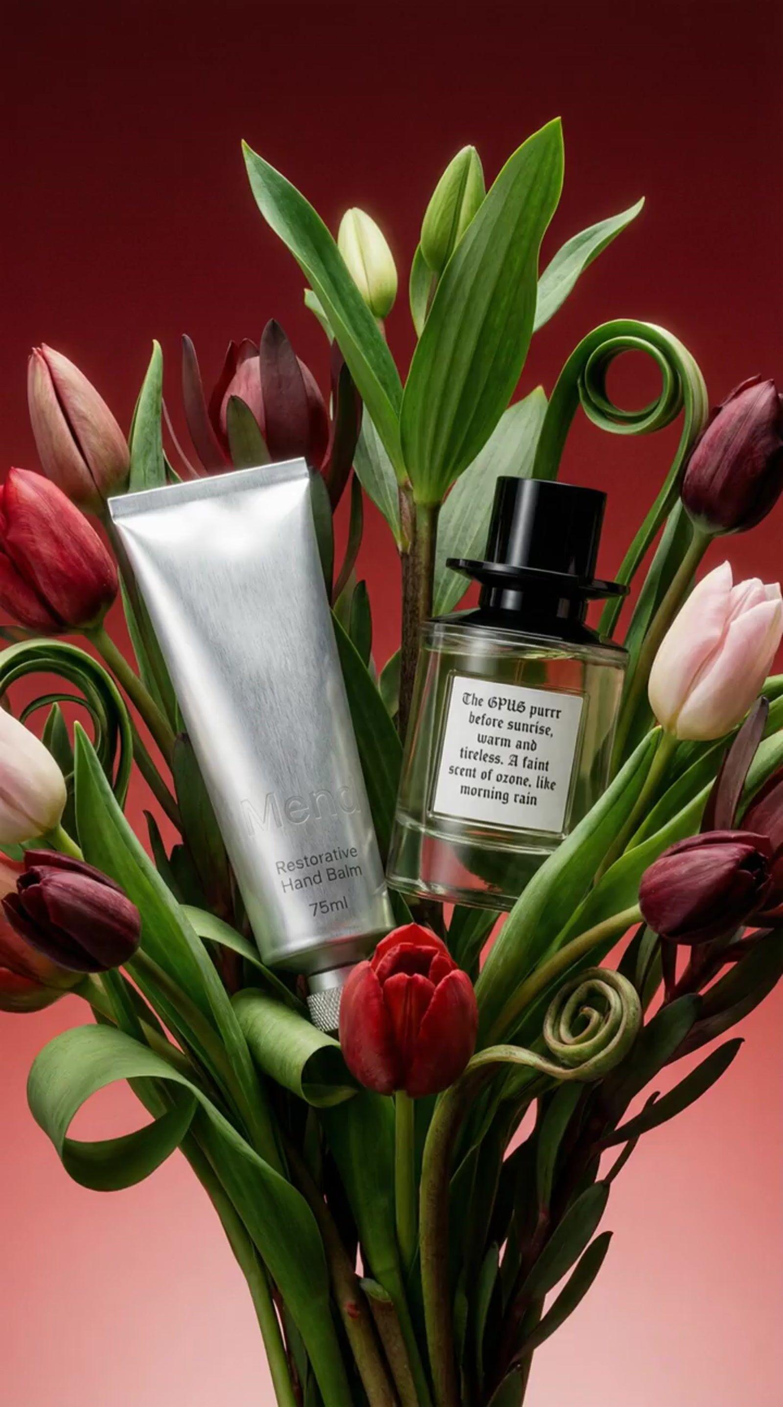 a vase filled with flowers and a bottle of perfume