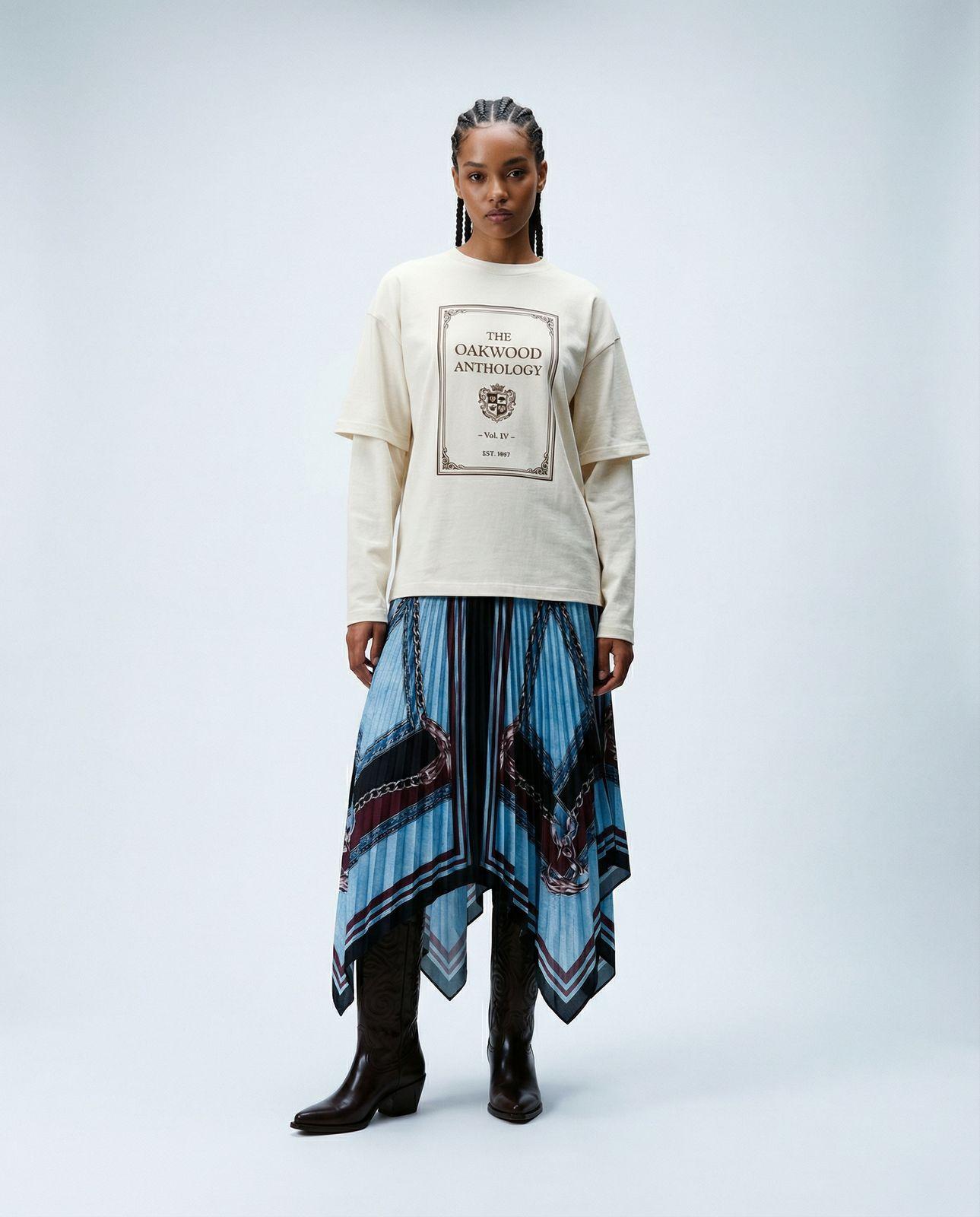a woman in a white shirt and blue skirt