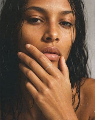 a close up of a person with a ring on her finger