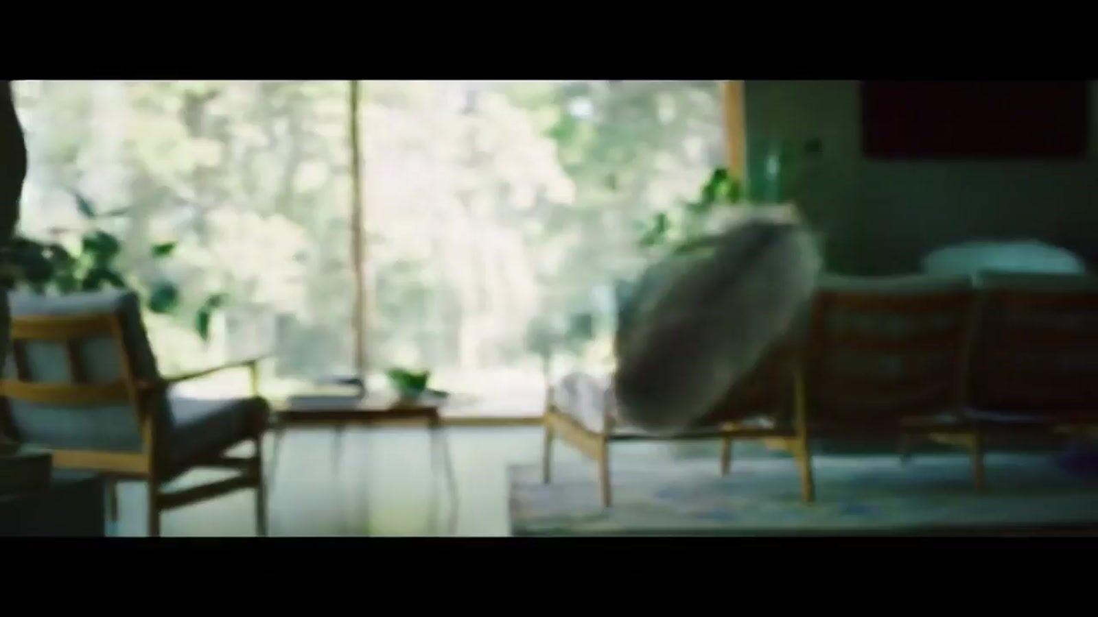 a blurry photo of a living room with a couch and chairs