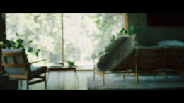 a blurry photo of a living room with a couch and chairs