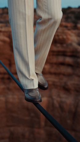 a person walking on a tight rope in a desert