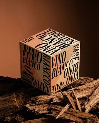 a box of wine sitting on top of a pile of wood