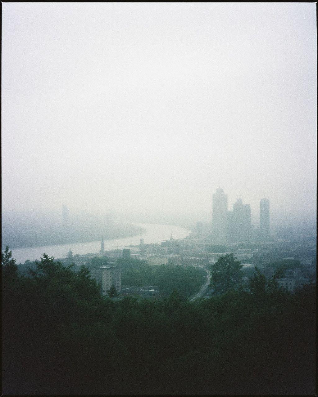 a foggy view of a city from a hill