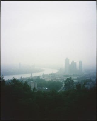 a foggy view of a city from a hill