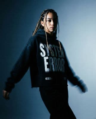 a woman with dreadlocks is posing for a picture