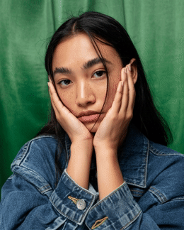 a woman with her hands on her face