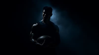 a man holding a basketball in the dark