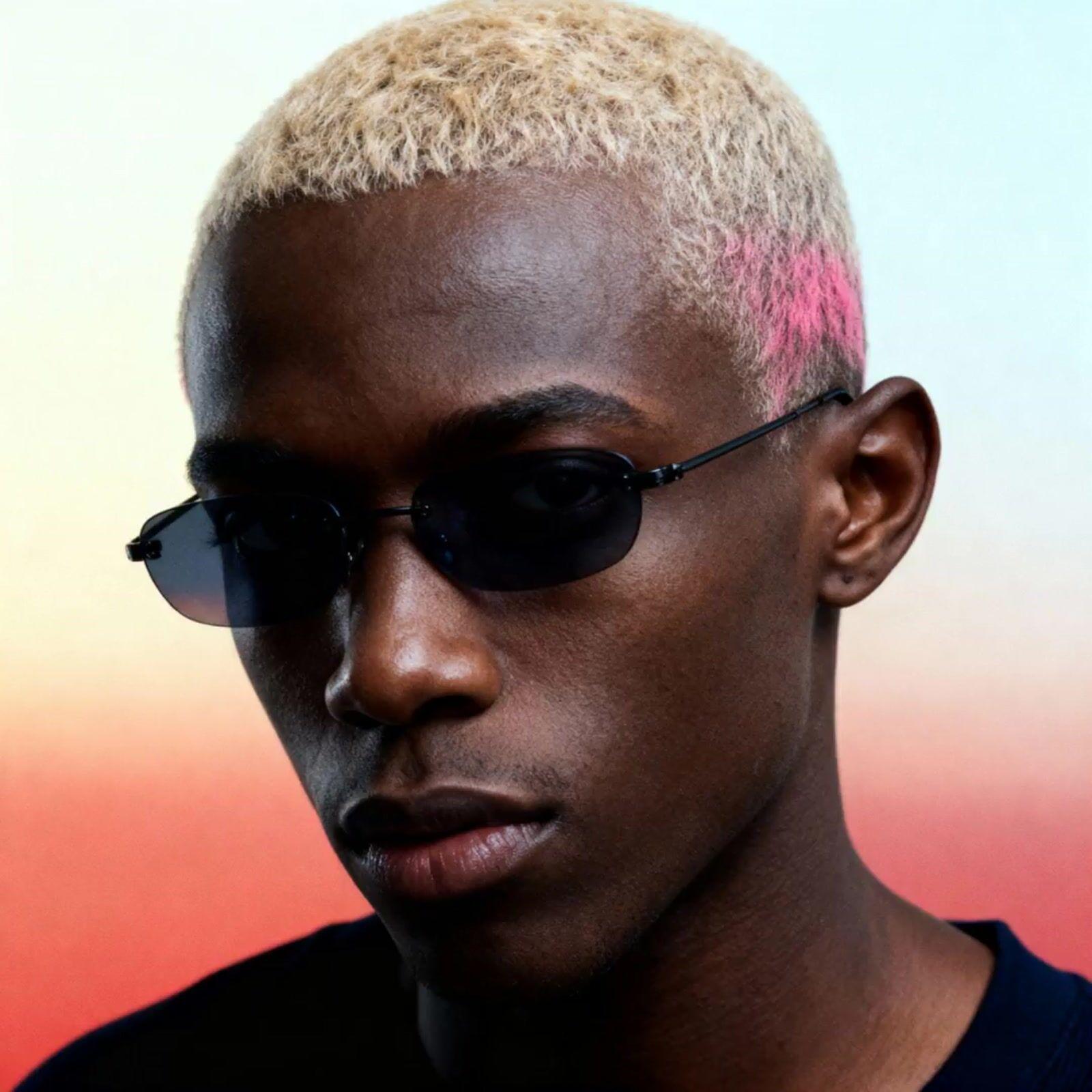 a man with a pink mohawk wearing sunglasses