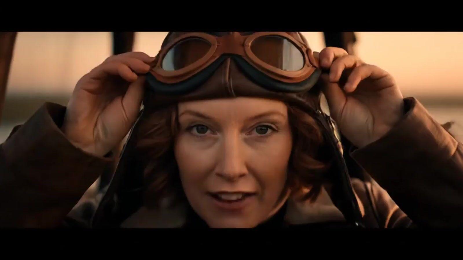 a woman wearing goggles and a leather jacket