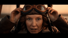 a woman wearing goggles and a leather jacket
