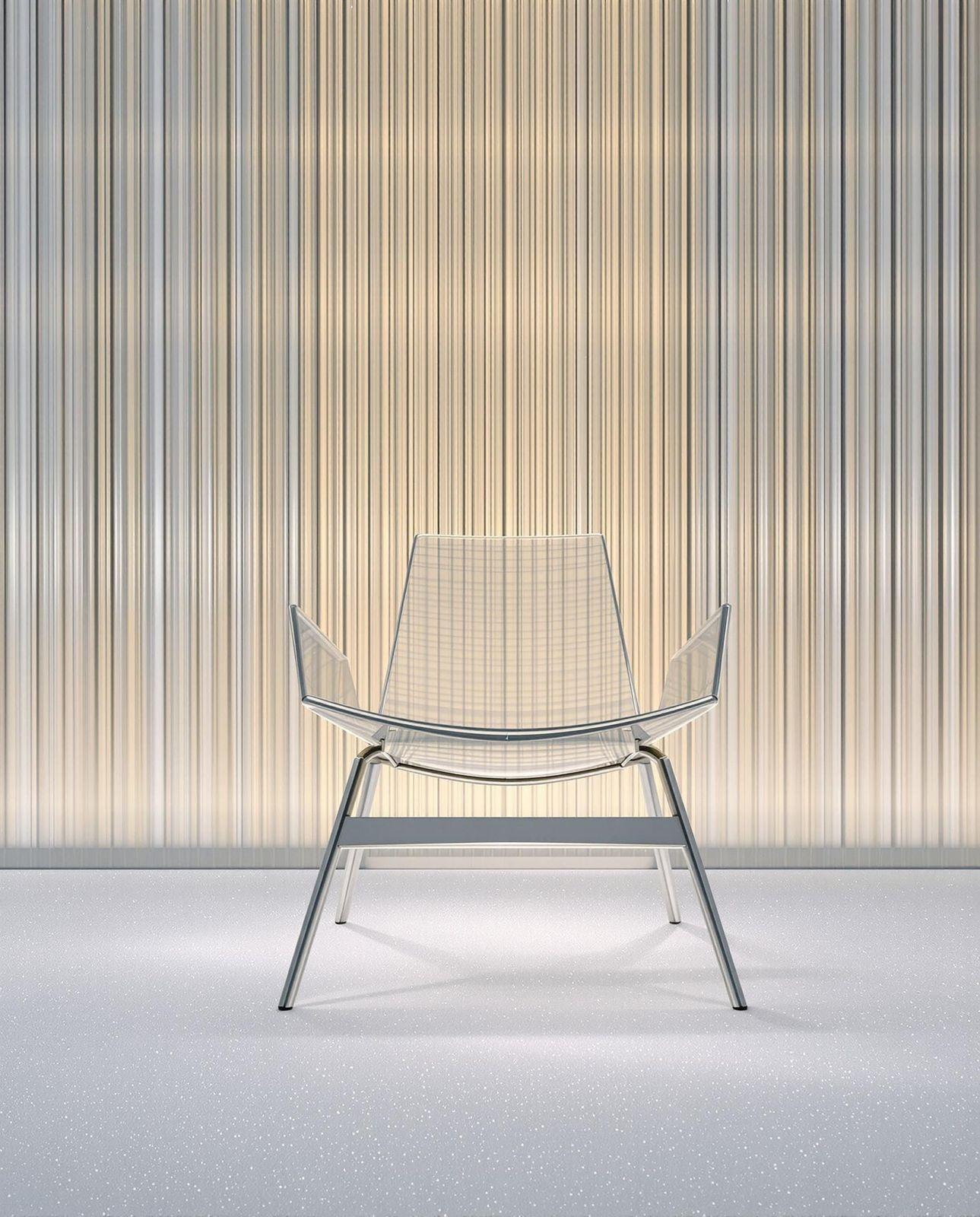 a white chair sitting in front of a wall