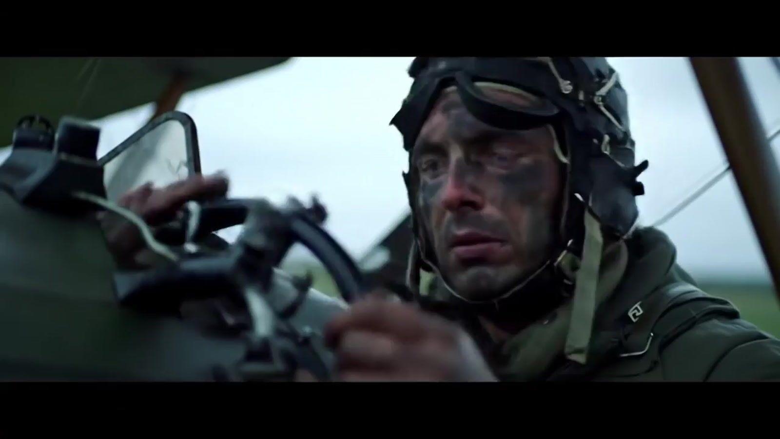 a man in a military uniform holding a machine