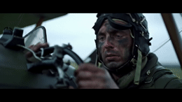 a man in a military uniform holding a machine