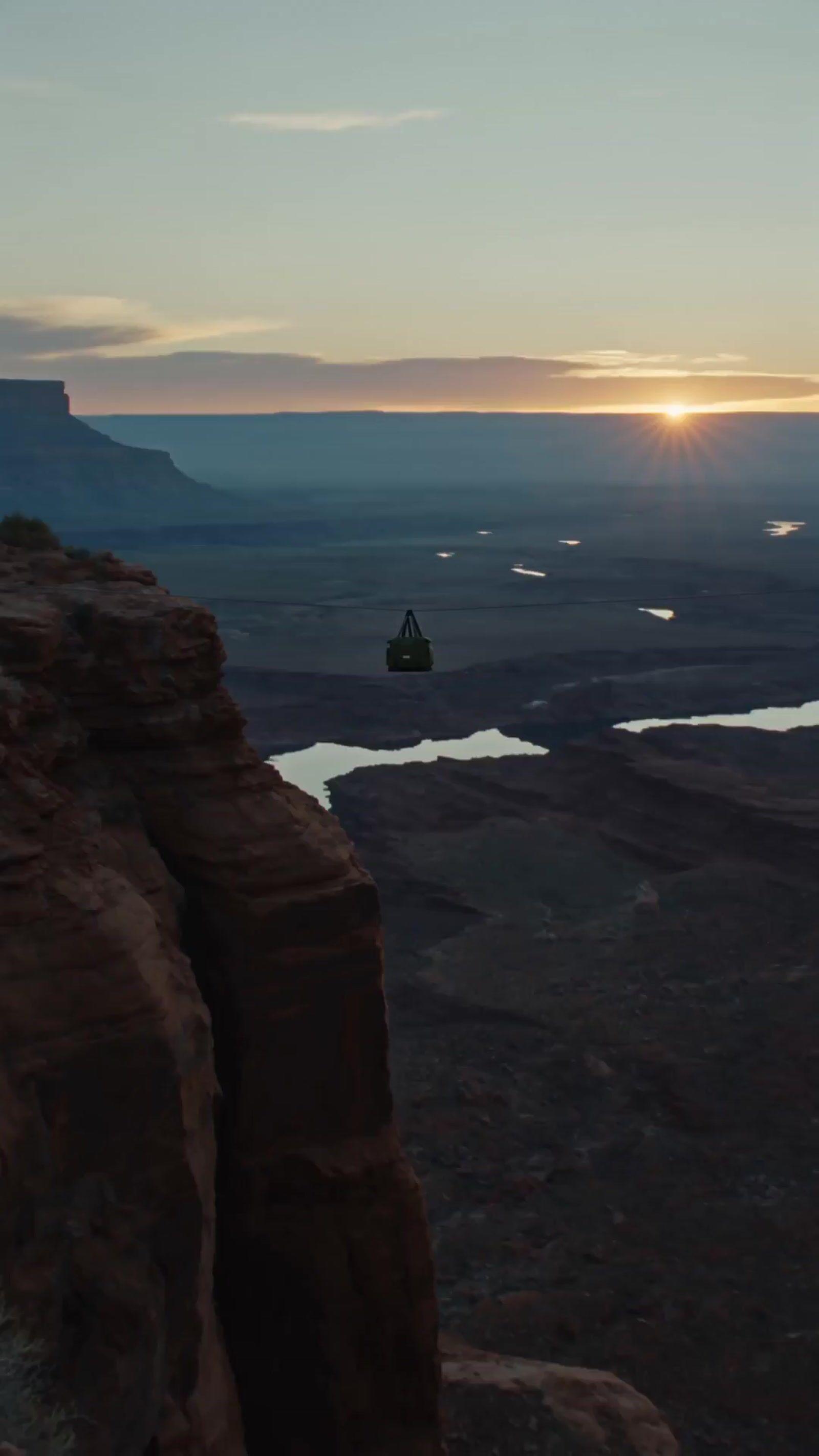 a person standing on a cliff overlooking a lake