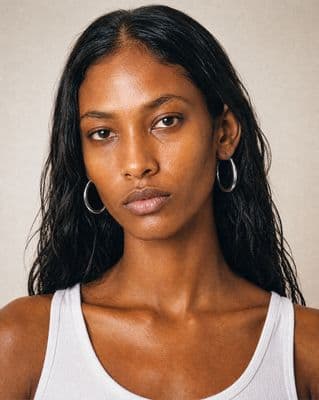 a close up of a person wearing a tank top