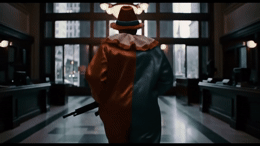 a person with a hat and a gun in a room