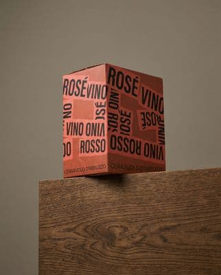 a stack of red boxes sitting on top of a wooden table