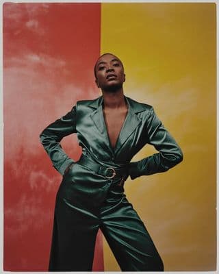 a woman standing in front of a colorful wall