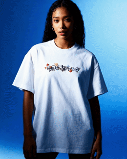 a woman standing in front of a blue background