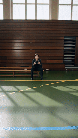 a man sitting on a bench in a gym