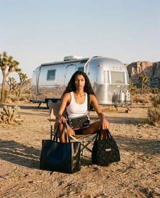 a woman sitting on a chair in front of a trailer