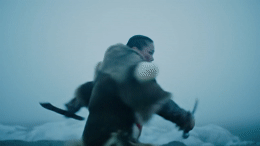 a blurry image of a man holding a snowboard